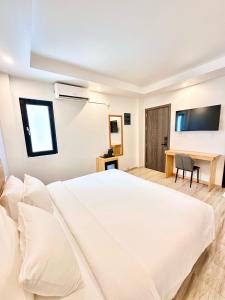 Voodi või voodid majutusasutuse AIMI Beach Hotel toas