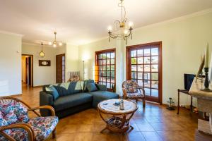 a living room with a couch and a table at Artemida Beachside Villa Escape - 50m by the Sea in Artemida