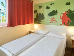Postel nebo postele na pokoji v ubytování B&B Hotel Aschaffenburg