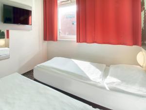 Postel nebo postele na pokoji v ubytování B&B Hotel Aschaffenburg