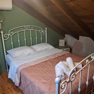 a bedroom with a large bed with a metal frame at Boho beach house in Nea Potidaea