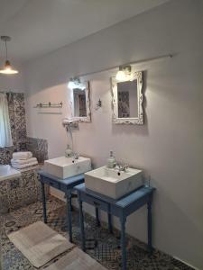 a bathroom with two sinks and a mirror and a tub at Pensiunea HAPPY in Schitu-Topolniţei +34 photos