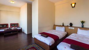 Postel nebo postele na pokoji v ubytování Hotel Khumbila