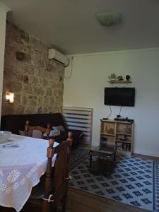 a living room with a table and a flat screen tv at Agica apartment in Škaljari