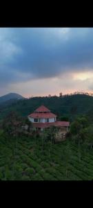 a house in the middle of a green field at Ck guest house in Devāla