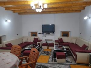 a living room with couches and a flat screen tv at Bujtina Mark Alia in Vrana