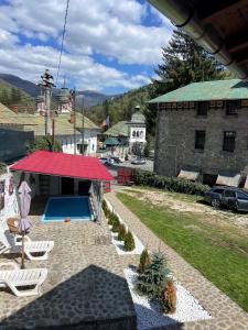 a resort with a swimming pool and a red roof at Casa SEMA in Sinaia