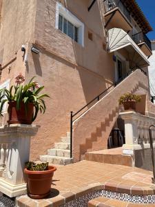 a building with stairs and potted plants in front of it at Hostal San Telmo - Adults Only in Palma de Mallorca +37 photos