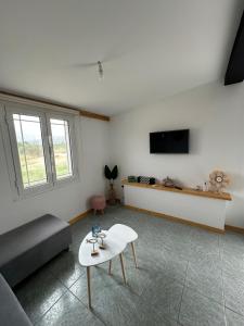 een woonkamer met een bank en een tafel bij Heras house in Iraion