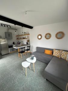 een woonkamer met een bank en een tafel en een keuken bij Heras house in Iraion