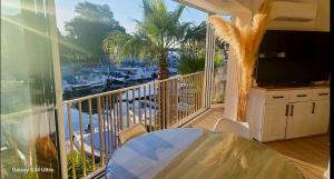 a balcony with a table and a view of a marina at Mandelieubeach06 in Mandelieu-La Napoule