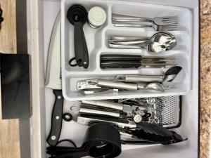 a drawer full of kitchen utensils in a box at Modern Oceanfront Apartment in Arecibo