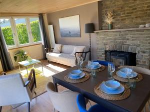 a living room with a table and a fireplace at Chalet de la Troquette in Fauvillers