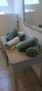 a pile of towels sitting on a table in a bathroom at chez Sandrine in La Gacilly +7 photos
