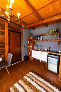 a living room with a tv and a table and a couch at Chale do Mirante in Blumenau