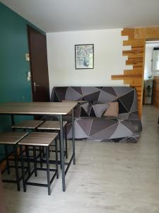a table and chairs in a room with a couch at Appartement Verrens in Verrens-Arvey