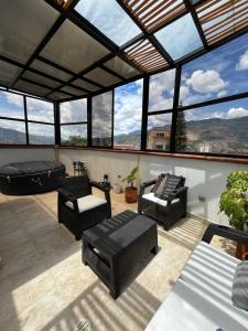 a living room with a lot of windows at nuevo amanecer in Bello