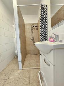 a white bathroom with a shower and a sink at Bepo in Zadar +25 photos
