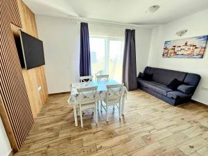 a living room with a table and chairs and a couch at Bepo in Zadar