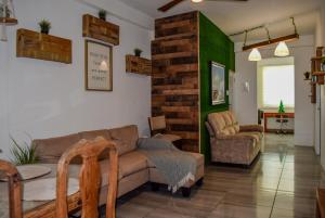a living room with a couch and a chair at VSS Rustic in Arecibo - Stylish & Relaxing Escape Near Beaches in Arecibo
