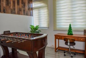a room with a foosball table and a desk at VSS Rustic in Arecibo - Stylish & Relaxing Escape Near Beaches in Arecibo