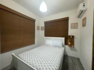 a bedroom with a bed in a room with windows at VSS Rustic in Arecibo - Stylish & Relaxing Escape Near Beaches in Arecibo