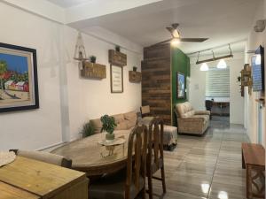a living room with a table and a couch at VSS Rustic in Arecibo - Stylish & Relaxing Escape Near Beaches in Arecibo
