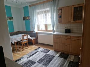 a small kitchen with a table and a window at Villa Auszeit in Kleinpöchlarn