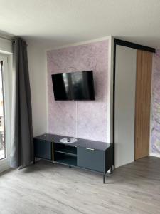 a living room with a tv on a wall at Seehaas1 in Friedrichshafen