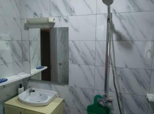 a bathroom with a sink and a mirror at Résidesnce Merveilles M18 in Kribi +40 photos