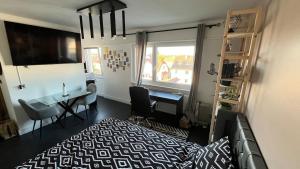 a bedroom with a bed and a desk and a window at Appartement cosy in Saint-Louis