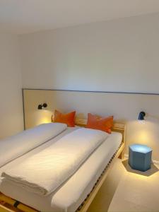 a bedroom with two beds with orange pillows at Casa Pradiei Dolomiti View in Cavareno