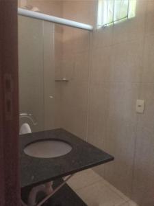 a bathroom with a sink and a toilet at Morada do rosa ouvidor in Garopaba