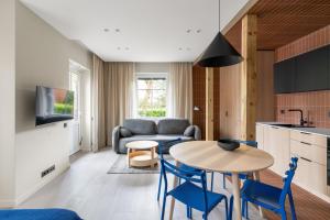 a kitchen and living room with a table and chairs at Ema in Palanga