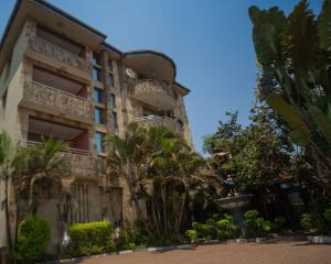 a building with a fountain in front of it at A Charming Retreat and Free Breakfast in Lubumbashi +6 photos