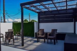 a group of chairs and a table on a patio at VSS Rustic in Arecibo - Stylish & Relaxing Escape Near Beaches in Arecibo