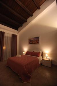 a bedroom with a large bed with two lamps at Centro storico apartment & Loft - Amnesia Holiday Home in Palermo