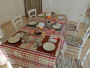 a table with a red and white checkered table cloth at B&B Villa Bello in Otranto +25 photos