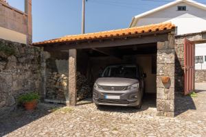 a car is parked inside of a garage at House Sopo in Vila Nova de Cerveira
