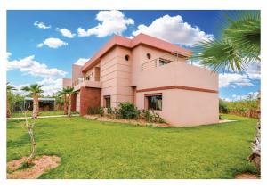 a house with a palm tree in front of it at Villa Dahlia Jacuzzi, Stove, Pool in Marrakesh