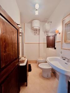 a bathroom with a sink and a toilet and a sink at La casa di Nonna Carissima in Villalago