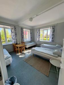 ハープサルにあるEndla Hostel ja Apartamendidのベッドルーム1室(ベッド2台、テーブル、椅子付)