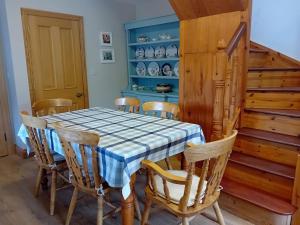a dining room with a table and chairs at Katie's Lodge in Tawnaghmore +14 photos