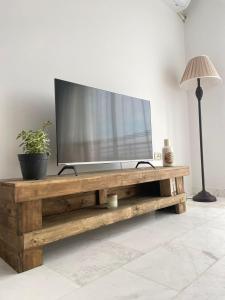 a television on a wooden table in a living room at Seven Sky appartment in Tunis in La Goulette
