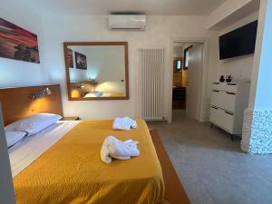 a hotel room with a bed with towels on it at Oasi verde cavallino in Cavallino di Lecce +62 photos