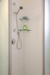 a shower with a shower head in a bathroom at GW002 Gugel Waves Amazing Seaview & Garden Family Apartments in Nahariyya +35 photos