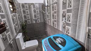 a bathroom with a toilet with a blue wheel in it at Galhena Villa in Tangalle +52 photos