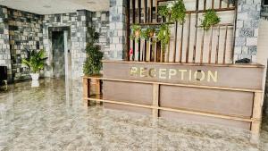 a reception desk in a lobby with a sign that reads reception at Baza Hotel Spa in Beylǝqan