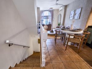 a living room with a staircase and a dining room at Casa Wanda in Estepona