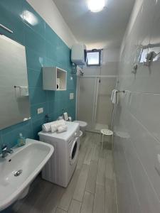 a bathroom with a white toilet and a sink at Casa vacanze SoleeMare Barletta Apartments in Barletta